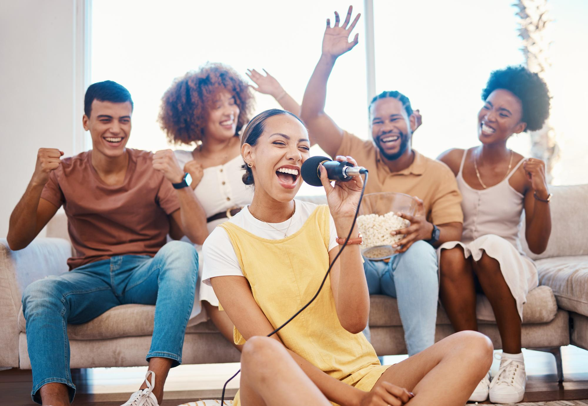 A group cheering and singing together during a lively karaoke session.